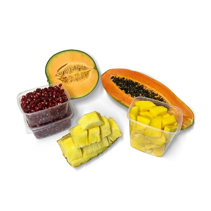 Halbe Melone und Papaya, Ananasstücke, Mangowürfel und Granatapfelkerne